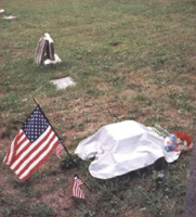 Chester's new tombstone, prior to its unveiling, with the flag of the United States flanked by two smaller flags of Liberia.