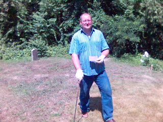George Nagle shows the burial plate that was found on a recent clean up day.
