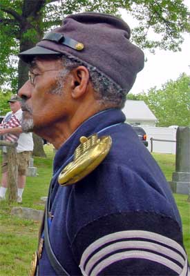 Sgt. Joe Lee of the 3rd USCT listens to the next speaker.