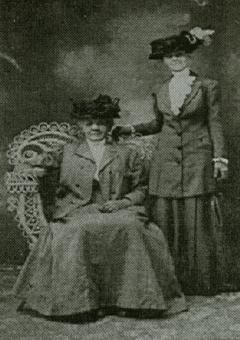 Jennie Roebuck, standing, early  twentieth century.  The seated woman is unidentified.