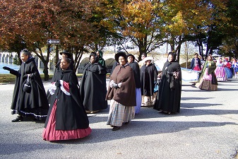 African American Civil War re-enactors parade on Front Street.