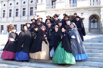 Civil war civilian re-enactors pose on Capitol steps after parade.